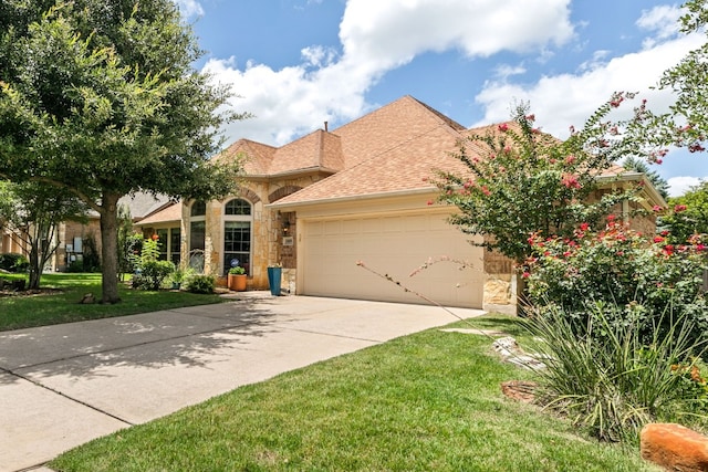 mediterranean / spanish house featuring a garage and a front yard