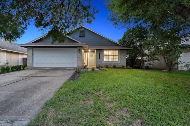 view of front of property featuring a garage and a lawn