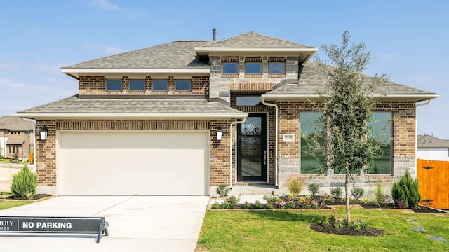 view of front of home with a front yard and a garage