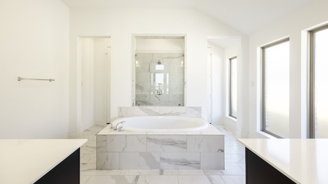 bathroom with vanity, lofted ceiling, and plus walk in shower