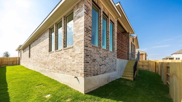 view of home's exterior with a lawn