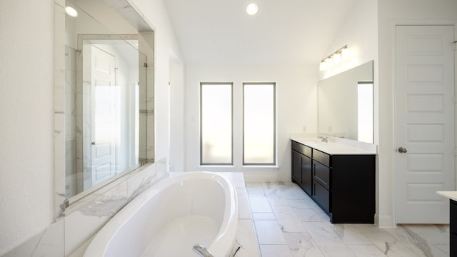 bathroom with vanity, separate shower and tub, and vaulted ceiling