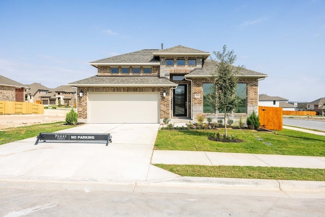 view of front of home featuring a front yard and a garage