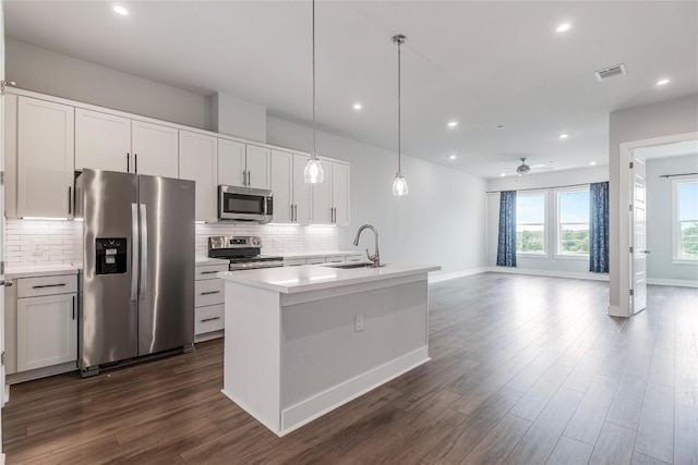 4507 E Martin Luther King Jr Blvd Unit 122, Austin, TX 78721 - kitchen featuring stainless steel appliances, decorative backsplash, dark wood-style flooring, light countertops, and recessed lighting
