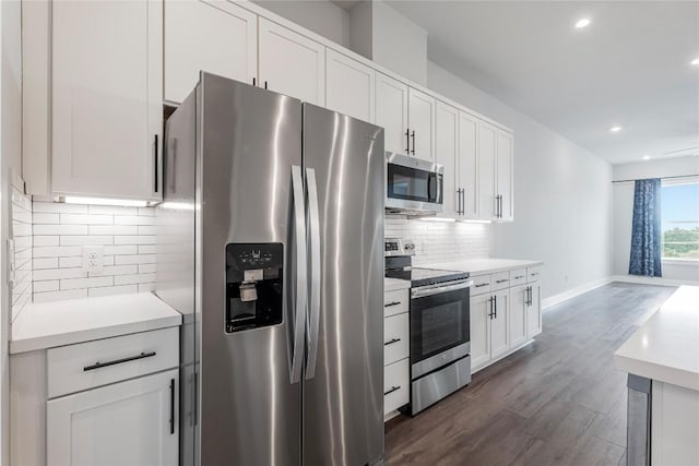 4507 E Martin Luther King Jr Blvd Unit 122, Austin, TX 78721 - kitchen with appliances with stainless steel finishes, backsplash, dark wood-style floors, light countertops, and white cabinets
