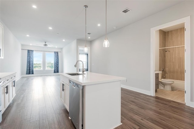 4507 E Martin Luther King Jr Blvd Unit 122, Austin, TX 78721 - kitchen featuring stainless steel dishwasher, a sink, white cabinetry, dark wood-type flooring, and light countertops