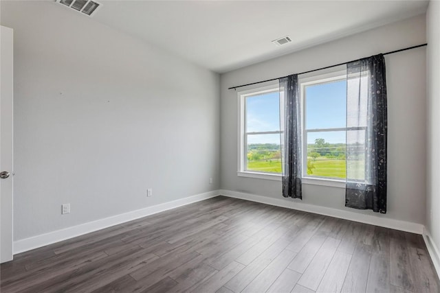4507 E Martin Luther King Jr Blvd Unit 122, Austin, TX 78721 - unfurnished room featuring dark wood-type flooring and baseboards