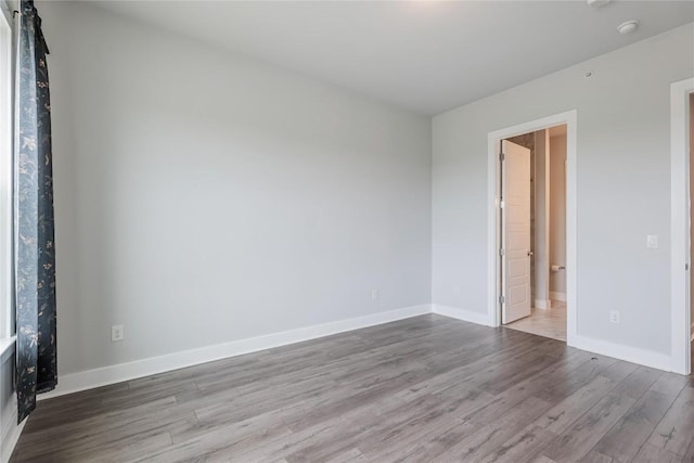 4507 E Martin Luther King Jr Blvd Unit 122, Austin, TX 78721 - spare room featuring wood finished floors, baseboards, and a smoke detector
