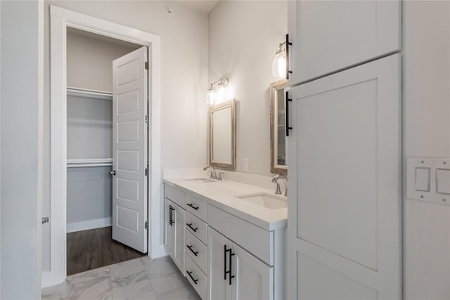 4507 E Martin Luther King Jr Blvd Unit 122, Austin, TX 78721 - bathroom with marble finish floors, double vanity, and baseboards
