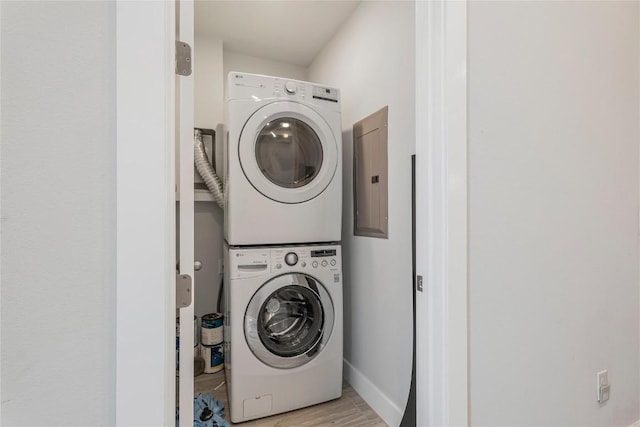 4507 E Martin Luther King Jr Blvd Unit 122, Austin, TX 78721 - laundry area featuring stacked washer / drying machine, light wood-style flooring, baseboards, and electric panel