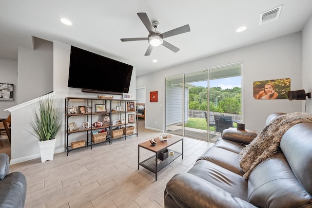 living area with light wood-type flooring, visible vents, and recessed lighting