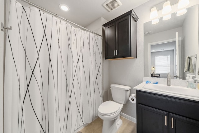 full bath with baseboards, visible vents, a textured wall, toilet, and vanity