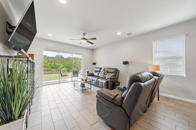 living area with recessed lighting, visible vents, a ceiling fan, light wood-type flooring, and baseboards