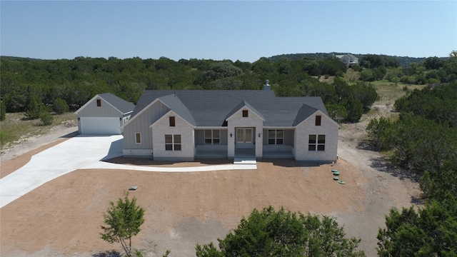 modern farmhouse style home with a garage and a porch