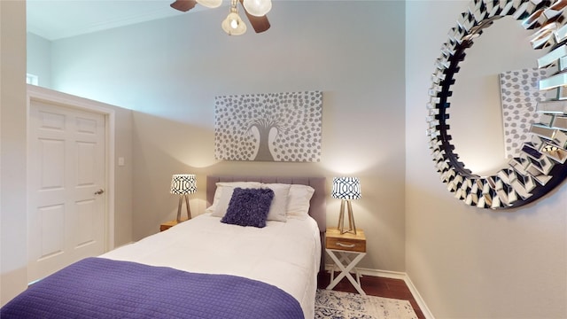 bedroom featuring hardwood / wood-style flooring, ceiling fan, and ornamental molding