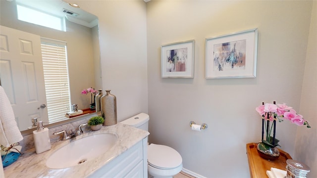 bathroom with vanity, plenty of natural light, and toilet