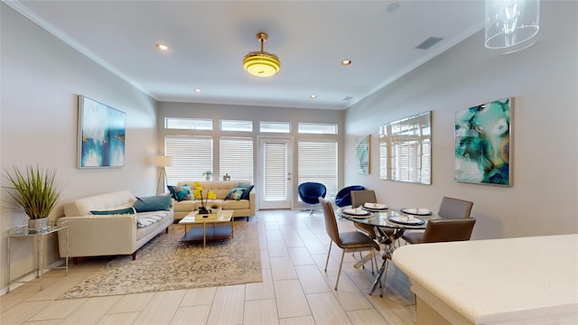 living room with crown molding and a healthy amount of sunlight