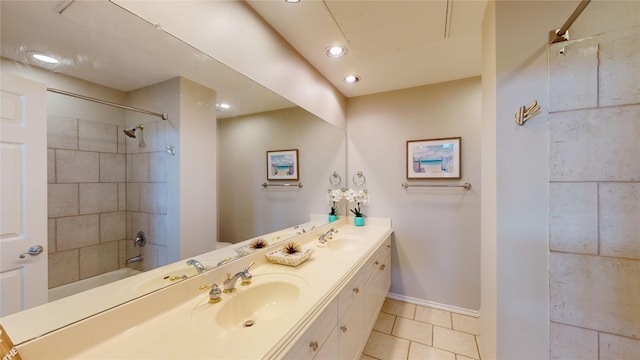 bathroom with vanity, tile patterned floors, and tiled shower / bath