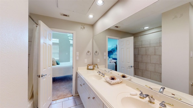 bathroom with vanity, curtained shower, and tile patterned floors