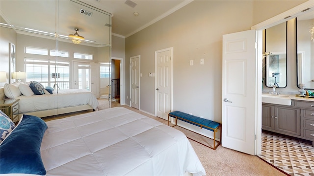 carpeted bedroom featuring connected bathroom, sink, vaulted ceiling, and ornamental molding