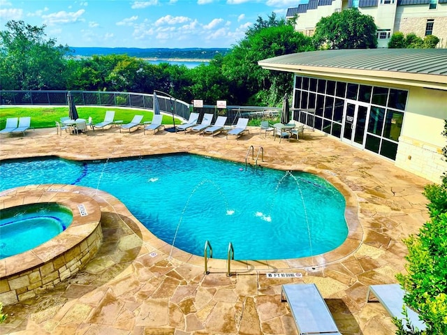 view of pool with a yard, a hot tub, a patio, and a sunroom