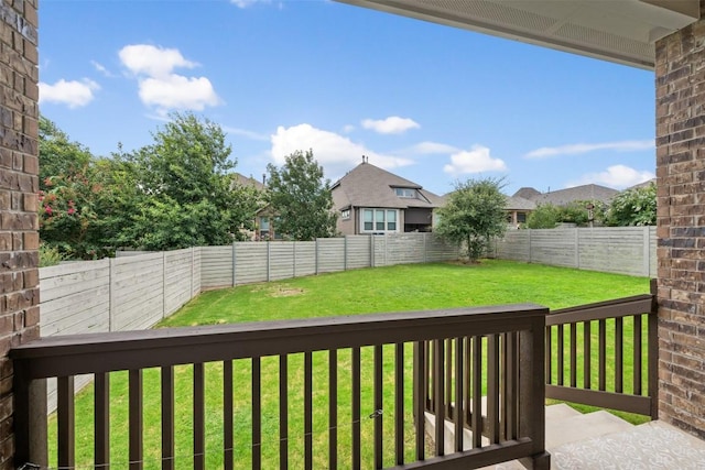 wooden terrace with a lawn