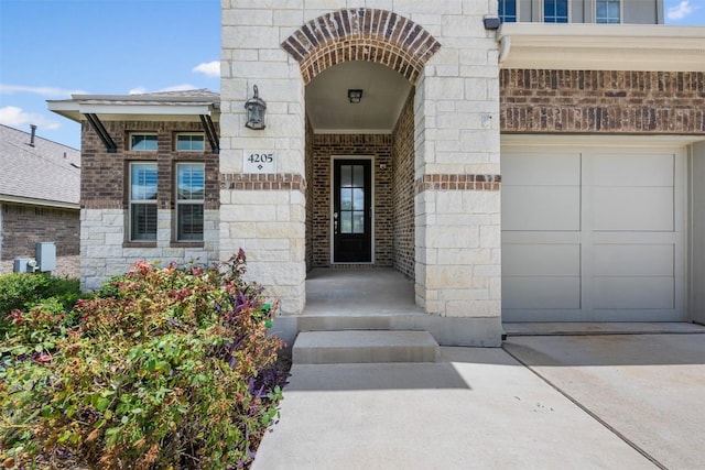 view of exterior entry with stone siding and brick siding