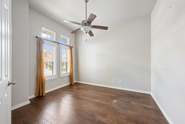 empty room with dark hardwood / wood-style floors and ceiling fan