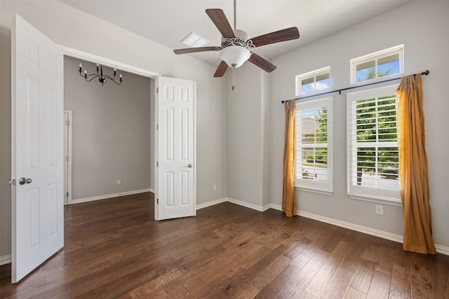 empty room featuring ceiling fan and dark wood-type flooring