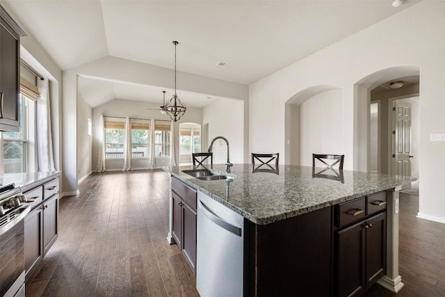 kitchen featuring dark hardwood / wood-style floors, lofted ceiling, appliances with stainless steel finishes, a center island with sink, and sink