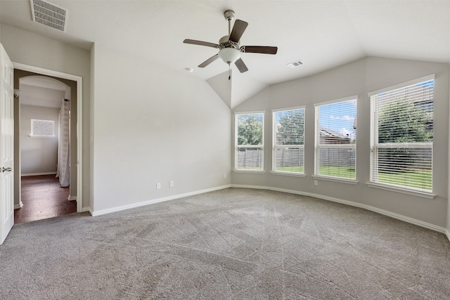 empty room featuring ceiling fan, hardwood / wood-style flooring, and lofted ceiling