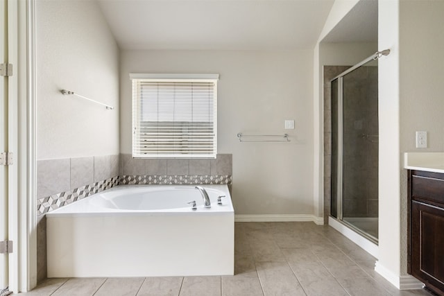 bathroom with plus walk in shower, vanity, and tile patterned floors