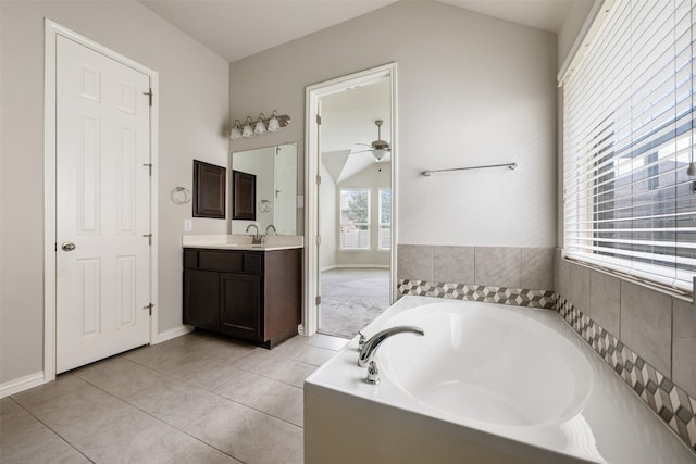 bathroom featuring tile patterned floors, vanity, a bathtub, and ceiling fan