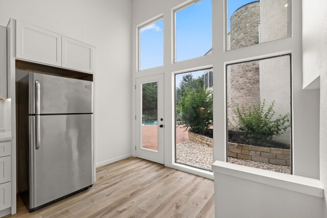 1 Crystal Springs Ct Unit G, The Hills, TX 78738 - doorway to outside with light wood-style floors and a high ceiling