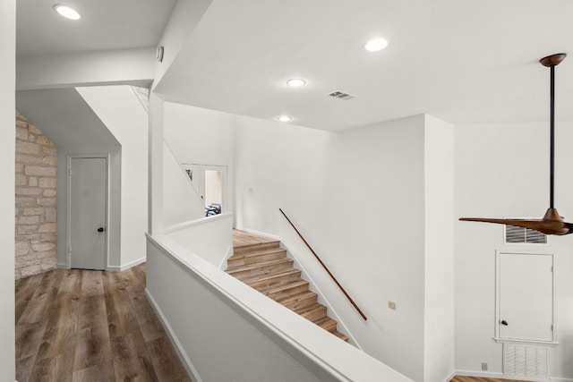 staircase featuring recessed lighting, wood finished floors, and visible vents