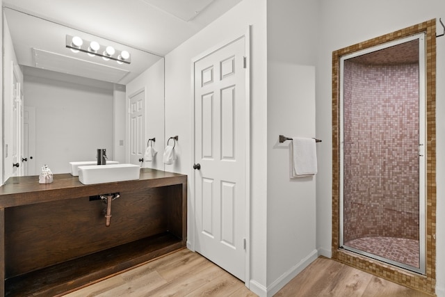 1 Crystal Springs Ct Unit G, The Hills, TX 78738 - full bathroom with wood finished floors, a stall shower, and vanity
