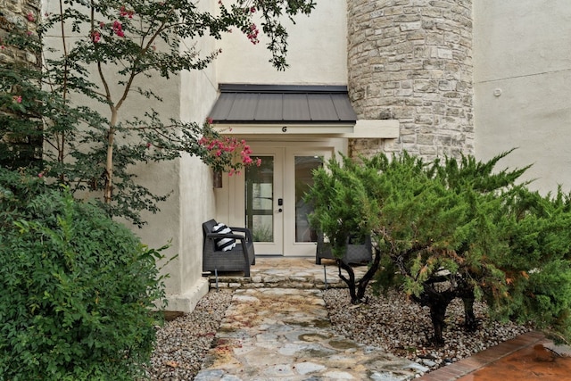 1 Crystal Springs Ct Unit G, The Hills, TX 78738 - doorway to property featuring french doors, stucco siding, a metal roof, and a standing seam roof