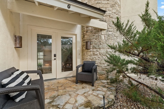 1 Crystal Springs Ct Unit G, The Hills, TX 78738 - view of exterior entry featuring french doors, stone siding, a patio area, and stucco siding