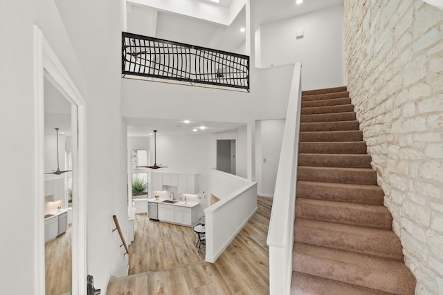 1 Crystal Springs Ct Unit G, The Hills, TX 78738 - stairway with wood finished floors, a high ceiling, and recessed lighting