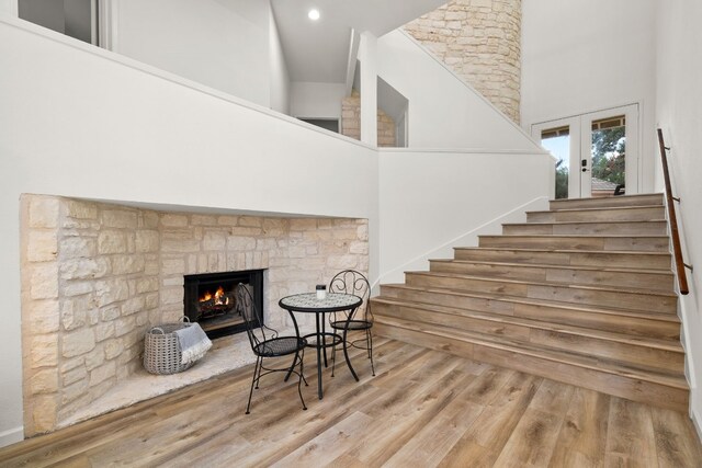 1 Crystal Springs Ct Unit G, The Hills, TX 78738 - stairs with a towering ceiling, a fireplace, wood finished floors, and recessed lighting