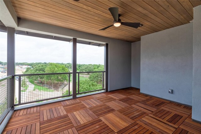 unfurnished room featuring wood ceiling, ceiling fan, and a wealth of natural light