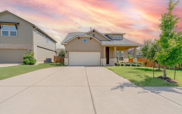 craftsman house featuring a garage and a yard