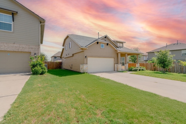 view of property with a garage and a yard