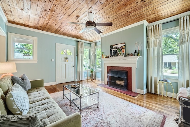 living room featuring a wealth of natural light, crown molding, and light wood-type flooring