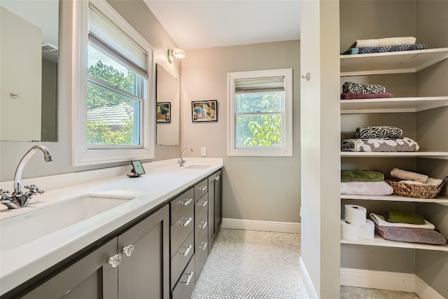 bathroom with double vanity and tile patterned floors