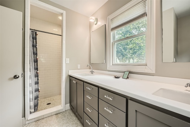 bathroom with walk in shower, tile patterned floors, and double sink vanity