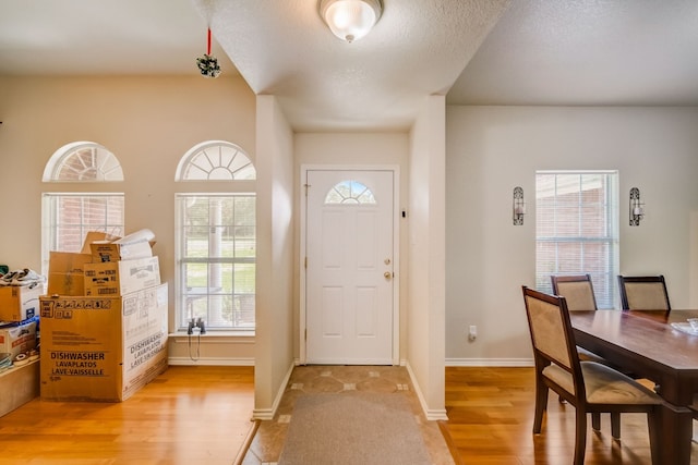 foyer featuring light hardwood / wood-style floors and a textured ceiling