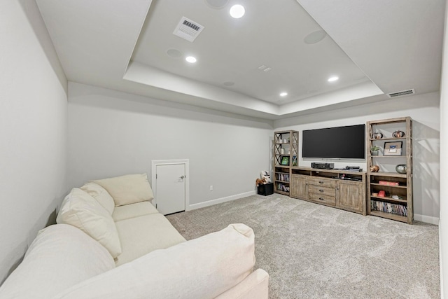 living room featuring light colored carpet and a raised ceiling