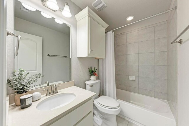 full bathroom featuring vanity, shower / bath combo, toilet, and tile patterned flooring