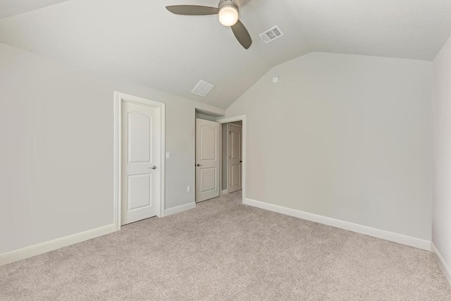 unfurnished bedroom featuring light carpet, lofted ceiling, and ceiling fan